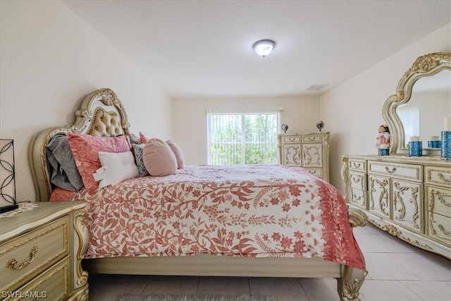 bedroom with light tile patterned floors