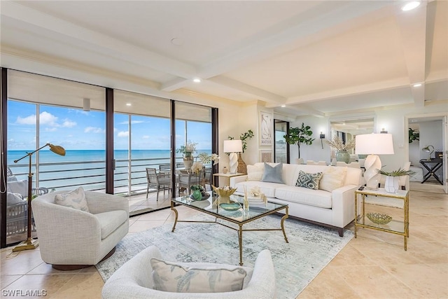 living room with beam ceiling, a water view, and a wall of windows