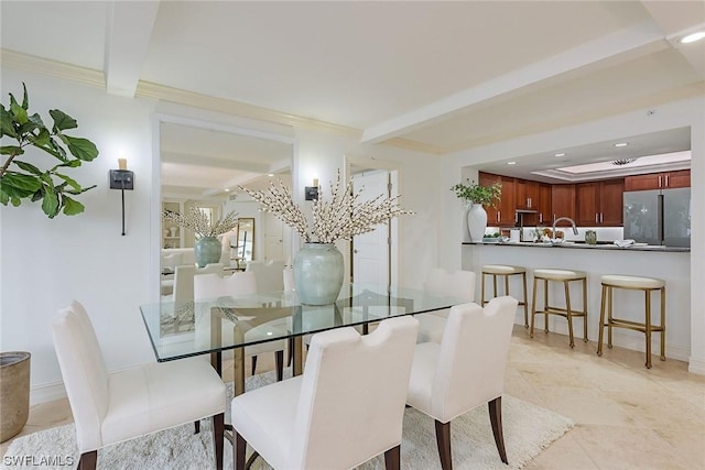 dining room with beamed ceiling and crown molding