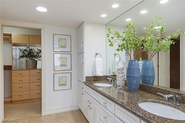 bathroom with tile patterned flooring and vanity