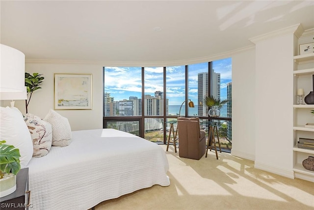 carpeted bedroom featuring crown molding and a wall of windows