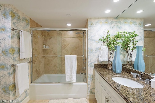 bathroom with vanity and bath / shower combo with glass door