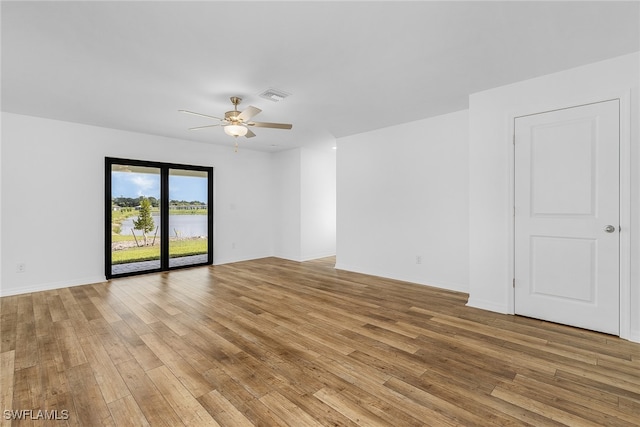 spare room featuring ceiling fan and light wood-type flooring