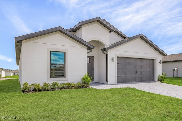 view of front of home with a garage and a front yard