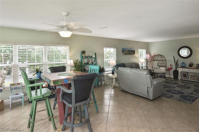 dining space featuring ceiling fan, light tile patterned flooring, and a healthy amount of sunlight