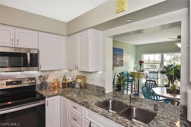 kitchen with white cabinets, stainless steel appliances, ceiling fan, and sink