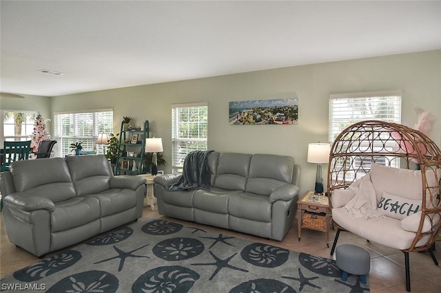 living room with a wealth of natural light and light tile patterned flooring