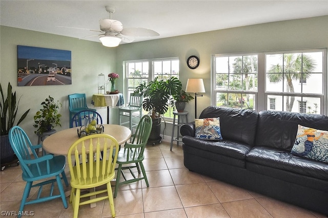 living room featuring a wealth of natural light, light tile patterned flooring, and ceiling fan