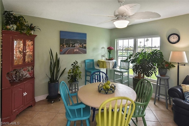 dining space featuring ceiling fan and light tile patterned flooring