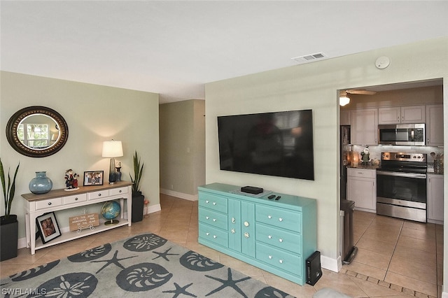 tiled living room featuring ceiling fan