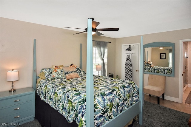 bedroom with a closet, tile patterned floors, and ceiling fan