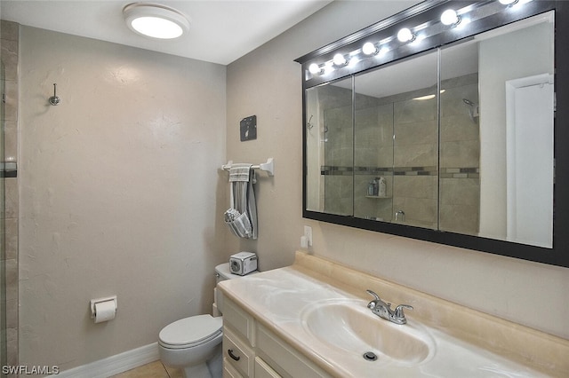 bathroom featuring vanity, toilet, and tiled shower