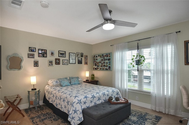 bedroom with ceiling fan and tile patterned flooring