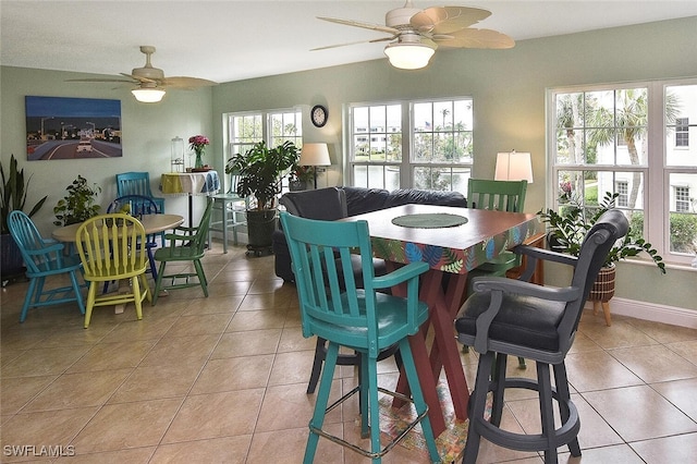 tiled dining space with ceiling fan