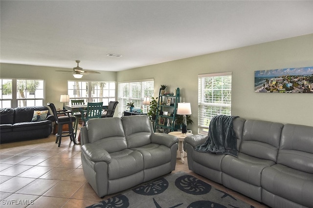 living room with ceiling fan and light tile patterned floors