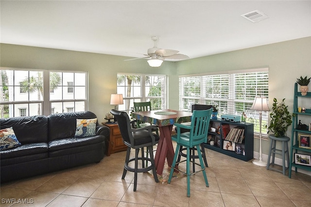 tiled dining room featuring ceiling fan