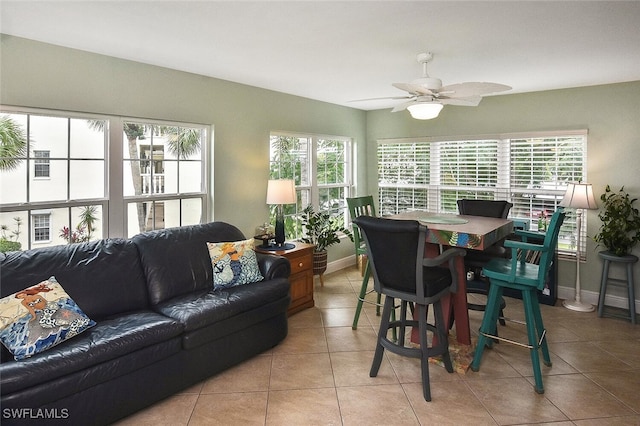 tiled dining area with ceiling fan