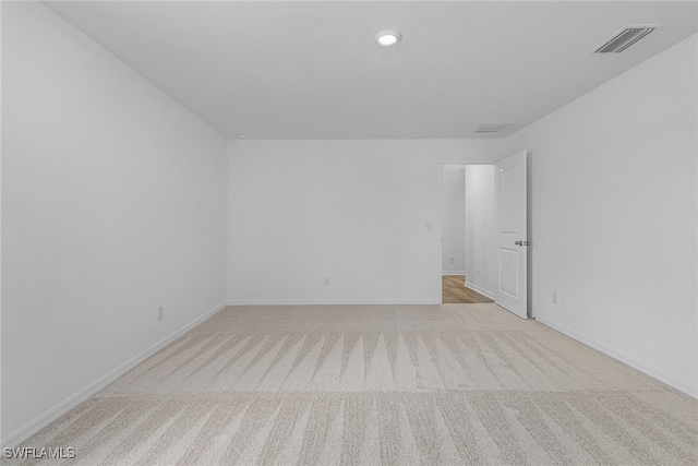 spare room featuring light carpet