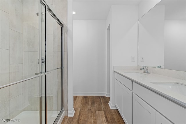 bathroom with vanity, wood-type flooring, and an enclosed shower