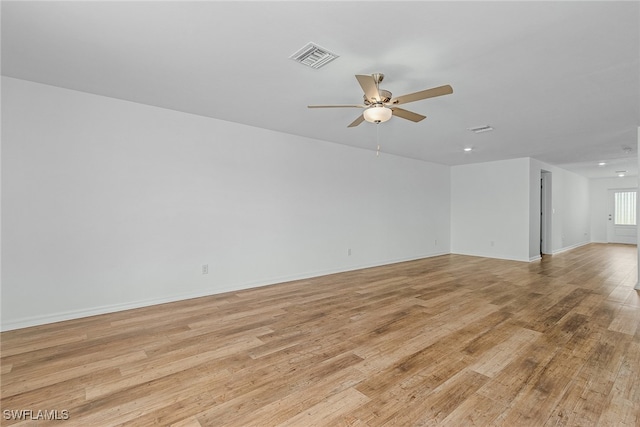 empty room featuring ceiling fan and light hardwood / wood-style floors