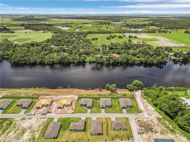 birds eye view of property with a water view and a rural view