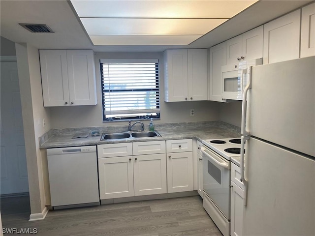 kitchen featuring white cabinetry, sink, white appliances, and light wood-type flooring