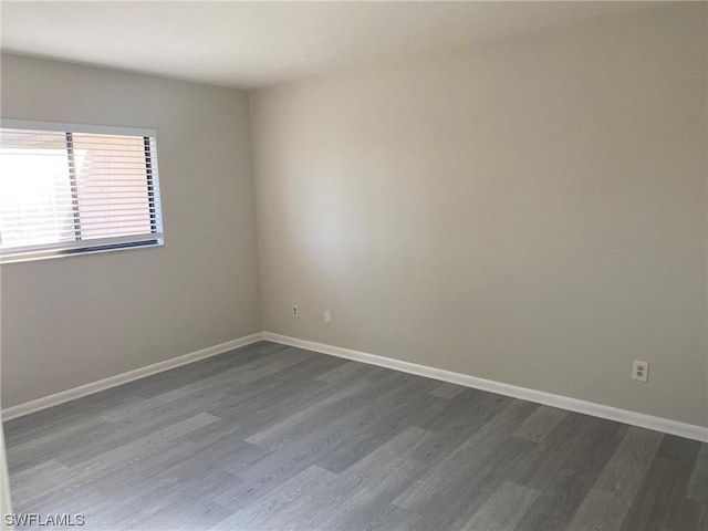 empty room with dark hardwood / wood-style floors