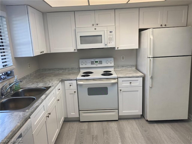 kitchen with sink, white cabinets, and white appliances