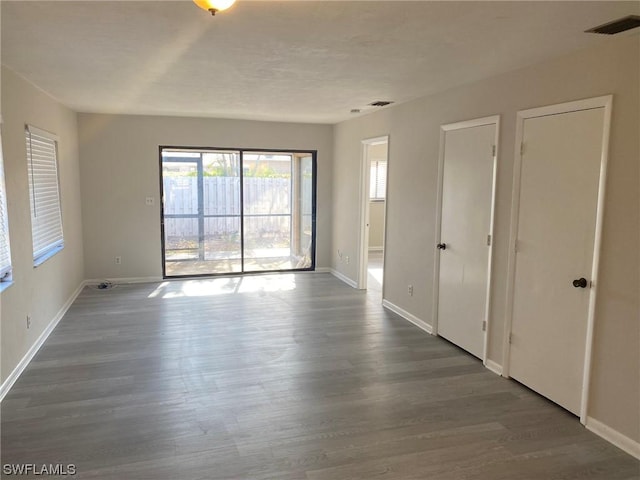 empty room with dark hardwood / wood-style floors