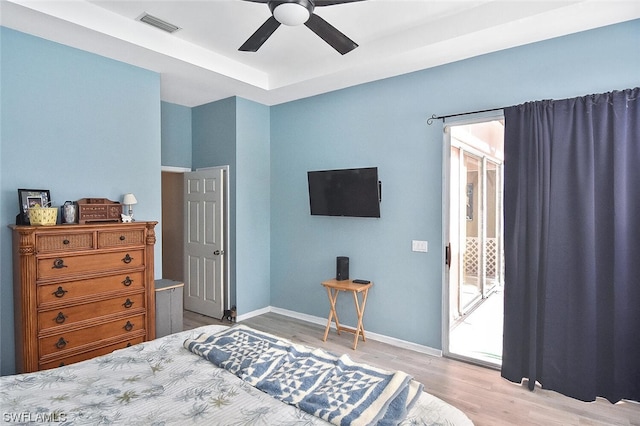 bedroom featuring access to exterior, ceiling fan, and light hardwood / wood-style floors