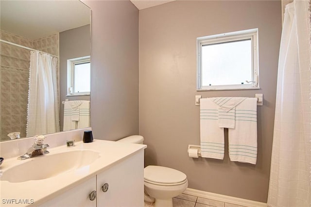 bathroom featuring tile patterned flooring, vanity, and toilet