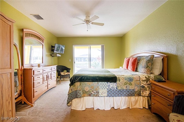 carpeted bedroom with access to outside and ceiling fan