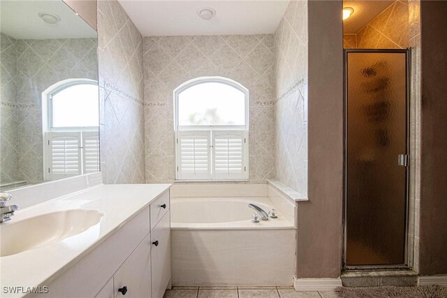 bathroom with tile patterned flooring, vanity, and separate shower and tub