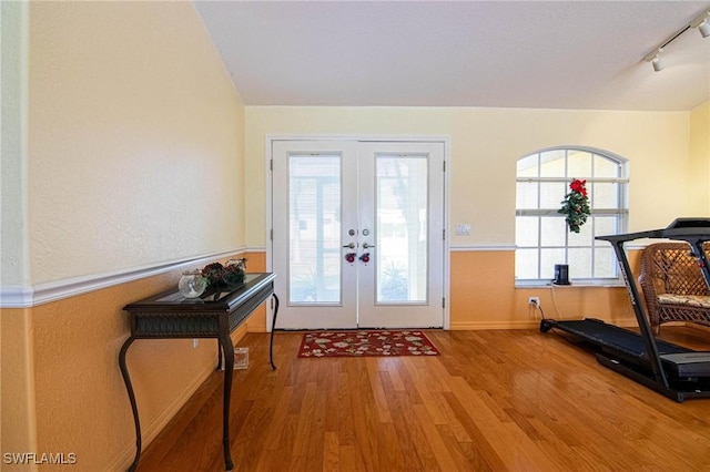 foyer entrance featuring french doors, hardwood / wood-style flooring, and track lighting