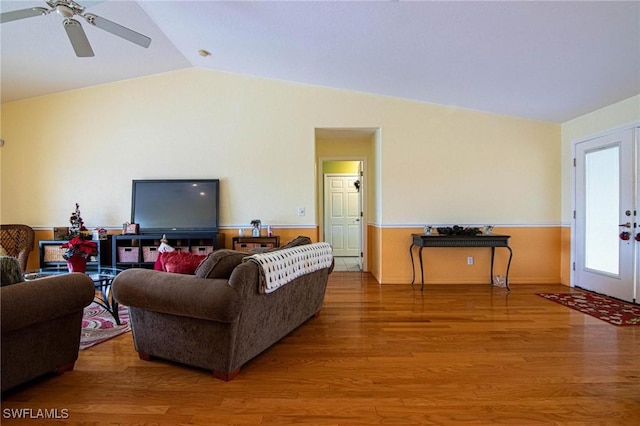 living room featuring ceiling fan, french doors, lofted ceiling, and hardwood / wood-style flooring