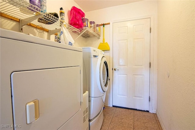 laundry area with light tile patterned flooring and independent washer and dryer