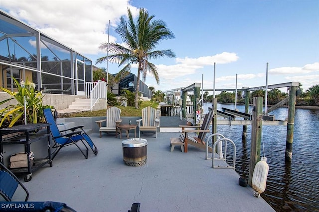 view of patio featuring a boat dock, a water view, and a lanai