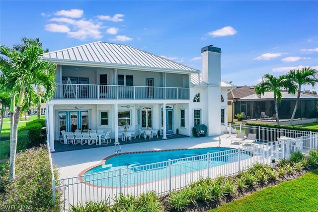 4630 SE 20th Ave, Cape Coral, FL 33904 - rear view of house featuring a fenced in pool, a patio area, french doors, and ceiling fan