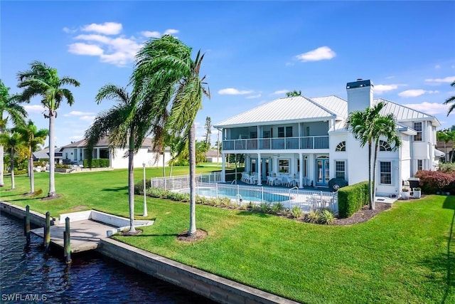 4630 SE 20th Ave, Cape Coral, FL 33904 - rear view of property with a water view, a balcony, a patio, and a lawn