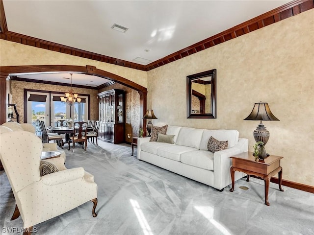 4630 SE 20th Ave, Cape Coral, FL 33904 - carpeted living room featuring an inviting chandelier and ornamental molding