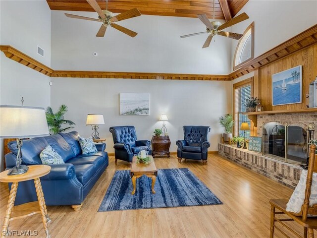 4630 SE 20th Ave, Cape Coral, FL 33904 - living room with hardwood / wood-style flooring, a fireplace, high vaulted ceiling, and ceiling fan