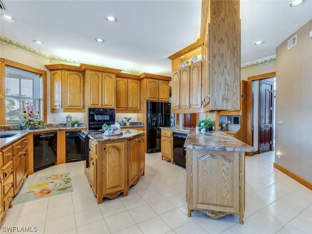 4630 SE 20th Ave, Cape Coral, FL 33904 - kitchen featuring a center island and black appliances