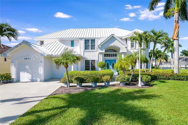 view of front of property featuring a garage and a front yard