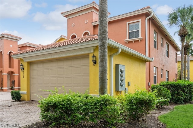 mediterranean / spanish house featuring a garage