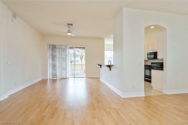 empty room with light hardwood / wood-style floors and ceiling fan