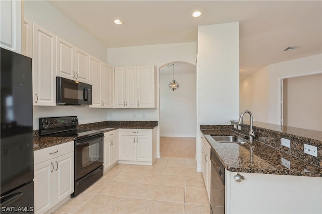 kitchen featuring black appliances, sink, dark stone countertops, white cabinets, and light tile floors