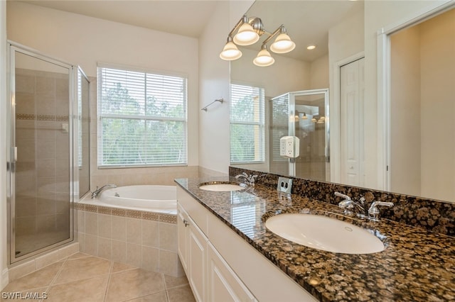 bathroom with tile floors, dual sinks, a chandelier, separate shower and tub, and oversized vanity