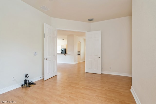 spare room with light hardwood / wood-style floors