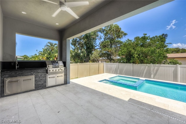 view of swimming pool with an in ground hot tub, area for grilling, exterior kitchen, and ceiling fan