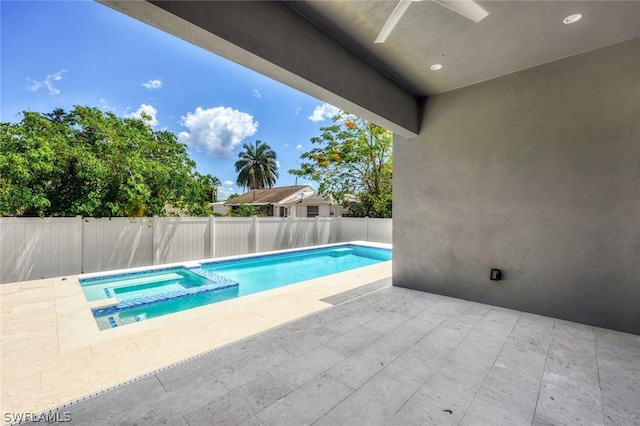 view of swimming pool with an in ground hot tub, ceiling fan, and a patio area